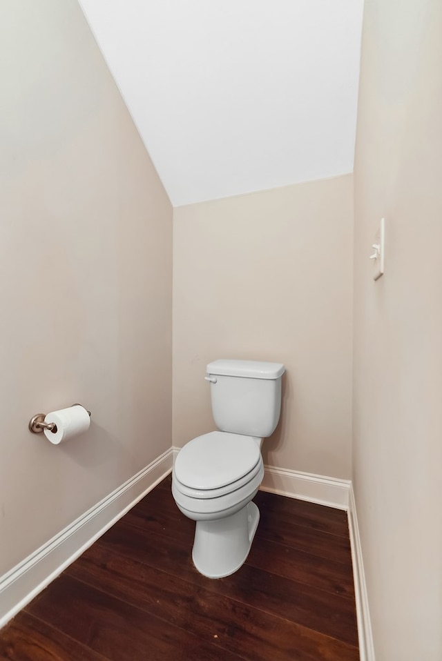 bathroom with lofted ceiling, wood-type flooring, and toilet