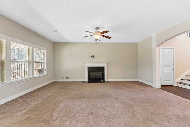 unfurnished living room featuring ceiling fan and carpet