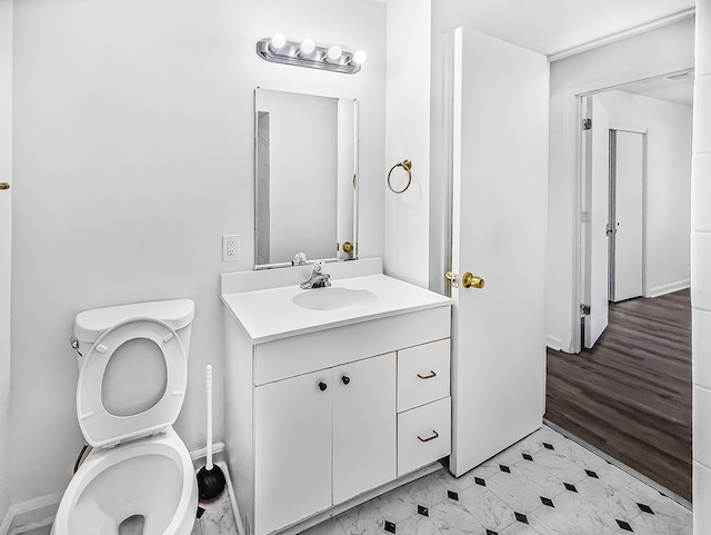 bathroom with toilet and vanity