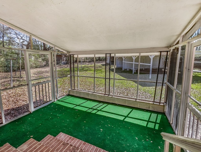 unfurnished sunroom featuring lofted ceiling