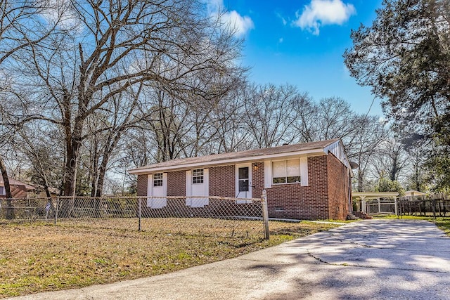 ranch-style home with brick siding, a fenced front yard, and aphalt driveway