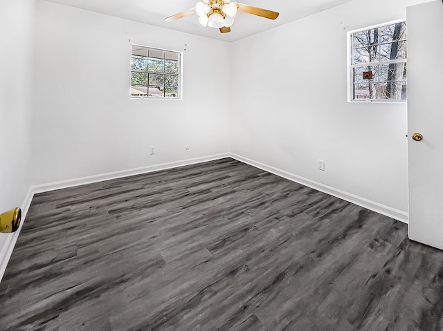 spare room featuring ceiling fan, baseboards, and dark wood-style flooring