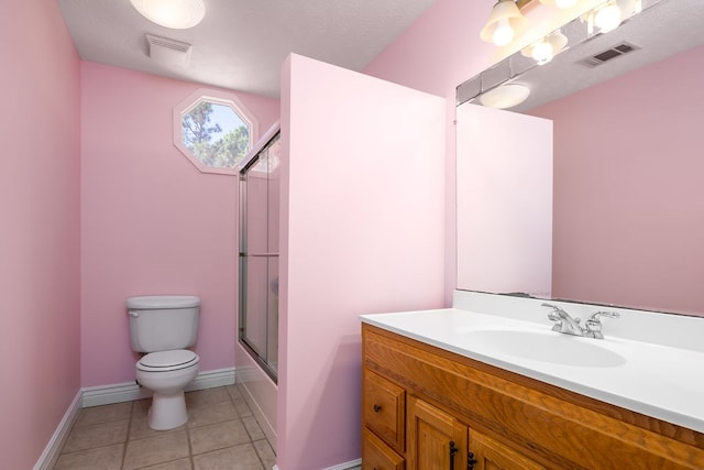 full bathroom with tile patterned floors, bath / shower combo with glass door, a textured ceiling, toilet, and vanity