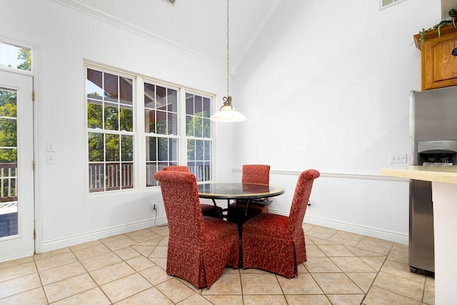 tiled dining room with high vaulted ceiling and ornamental molding