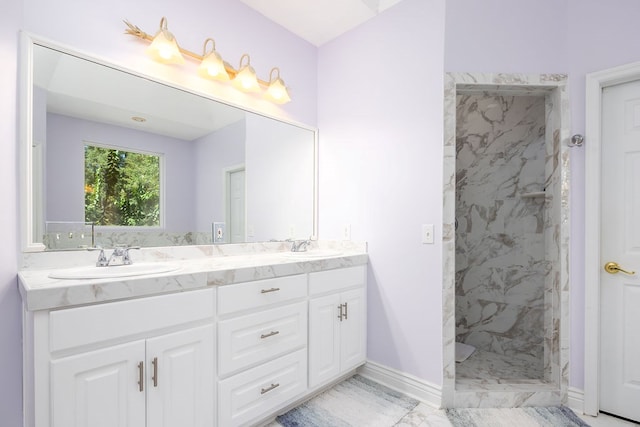 bathroom featuring a tile shower and vanity