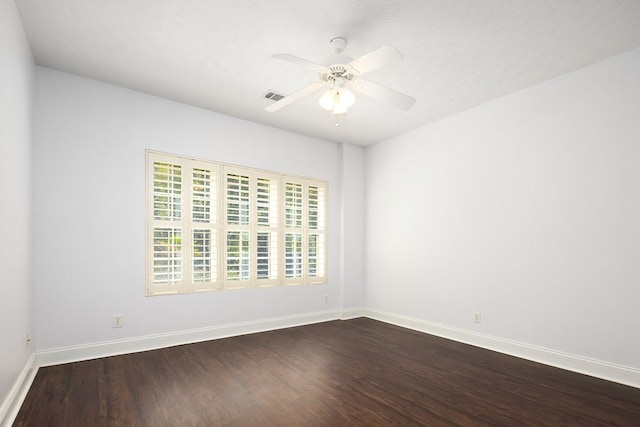 unfurnished room featuring ceiling fan and dark hardwood / wood-style flooring