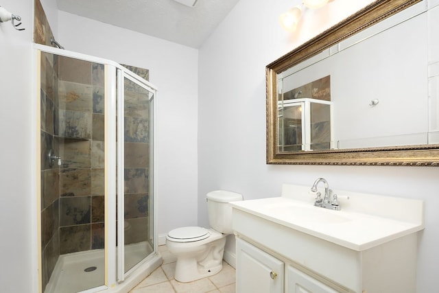 bathroom with vanity, tile patterned floors, toilet, a textured ceiling, and a shower with shower door