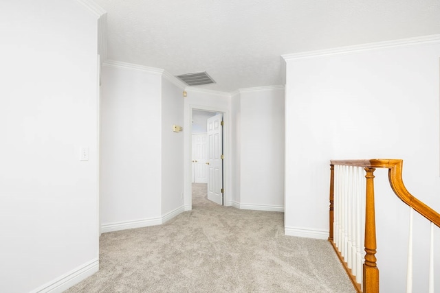 carpeted spare room featuring ornamental molding