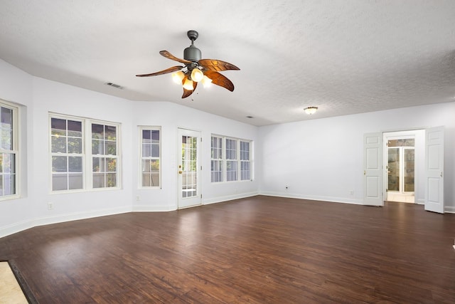 unfurnished living room with a textured ceiling, ceiling fan, and dark wood-type flooring