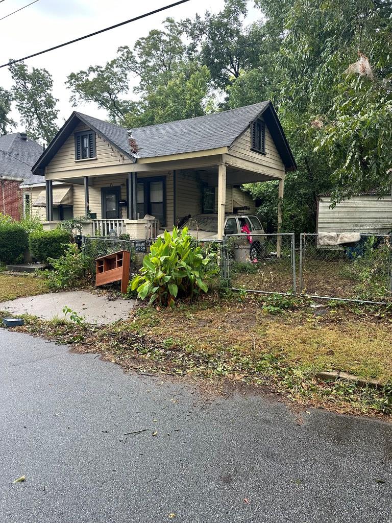 bungalow with a porch and a carport