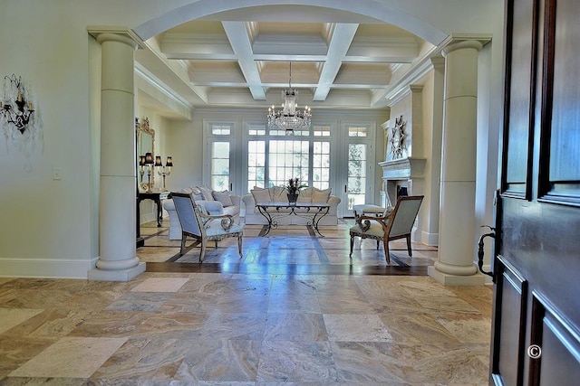 sitting room featuring decorative columns, ornamental molding, coffered ceiling, beam ceiling, and an inviting chandelier