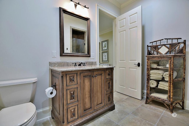 bathroom with vanity, toilet, and ornamental molding