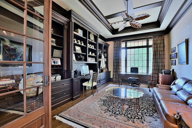 home office featuring ceiling fan, french doors, dark wood-type flooring, crown molding, and built in desk