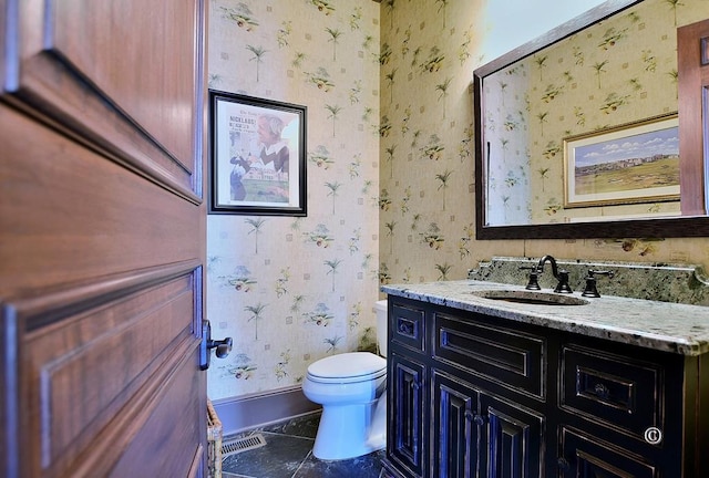 bathroom featuring tile patterned flooring, vanity, and toilet