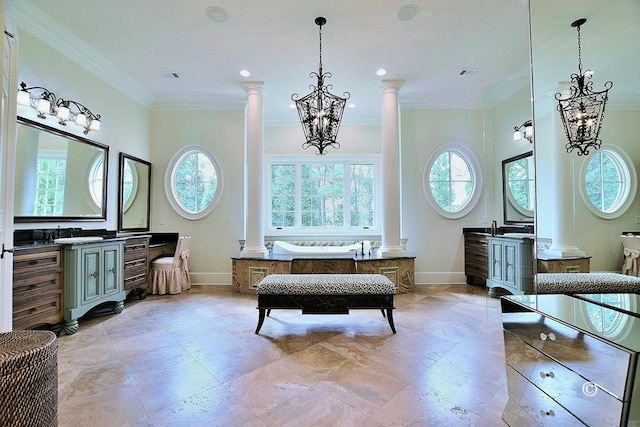 bathroom featuring decorative columns, crown molding, and a healthy amount of sunlight