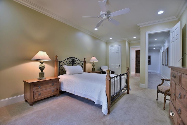 bedroom featuring ceiling fan, light colored carpet, ornamental molding, and a closet