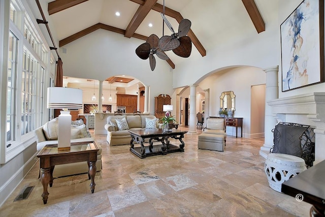 living room featuring beam ceiling, ceiling fan, and high vaulted ceiling