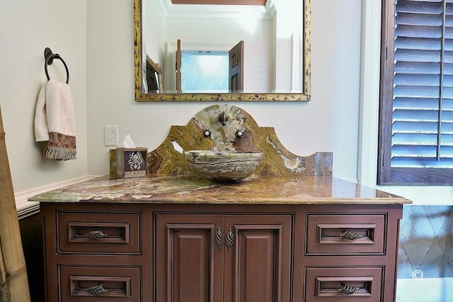 bathroom with vanity and ornamental molding