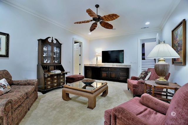 carpeted living room featuring ceiling fan and crown molding