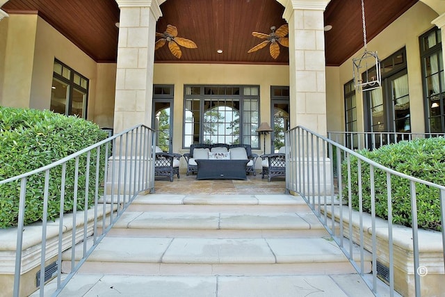 view of exterior entry featuring outdoor lounge area, a porch, and ceiling fan