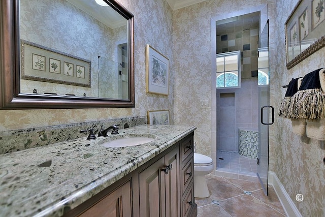 bathroom featuring tile patterned flooring, vanity, toilet, and a shower with door