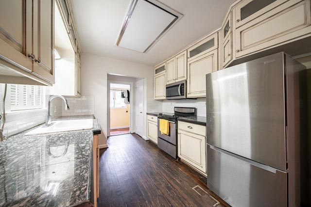 1518 Preston Dr, Columbus, GA 31906 - kitchen with stainless steel appliances, cream cabinets, a sink, and dark wood-style flooring