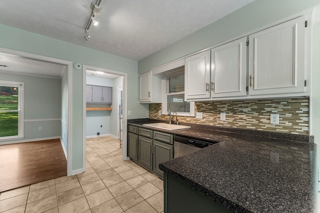 1506 Lokey Dr, Columbus, GA 31904 - kitchen with a sink, dark countertops, tasteful backsplash, white cabinets, and a textured ceiling