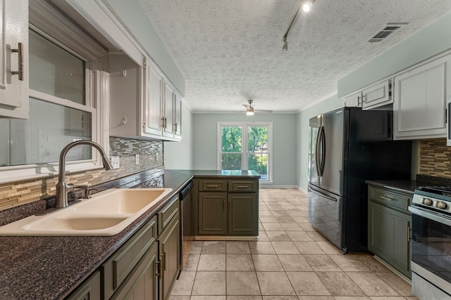 1506 Lokey Dr, Columbus, GA 31904 - kitchen with a sink, stainless steel appliances, tasteful backsplash, a ceiling fan, and a peninsula