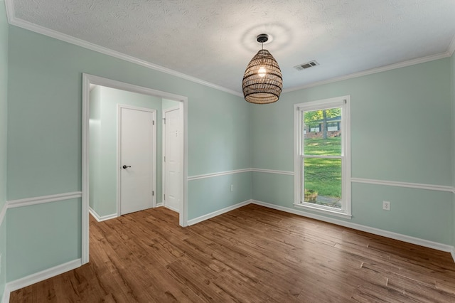 1506 Lokey Dr, Columbus, GA 31904 - empty room with wood finished floors, baseboards, crown molding, a textured ceiling, and a chandelier