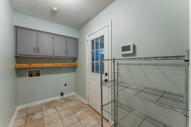 1506 Lokey Dr, Columbus, GA 31904 - washroom featuring electric dryer hookup, washer hookup, cabinet space, baseboards, and a textured ceiling