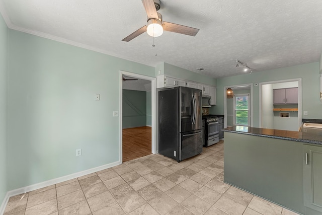 1506 Lokey Dr, Columbus, GA 31904 - kitchen featuring appliances with stainless steel finishes, a ceiling fan, baseboards, a textured ceiling, and white cabinetry