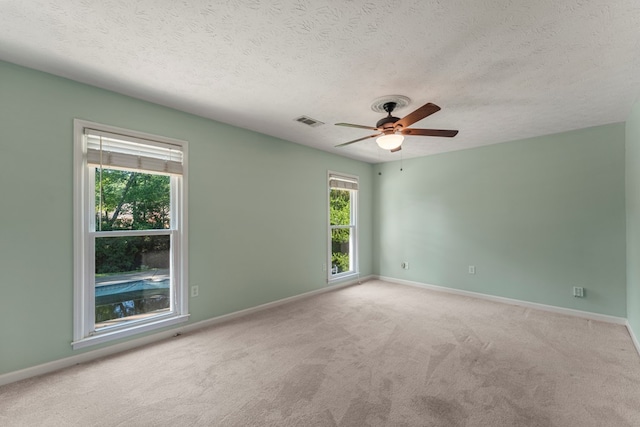 1506 Lokey Dr, Columbus, GA 31904 - empty room featuring ceiling fan, carpet flooring, a textured ceiling, and baseboards