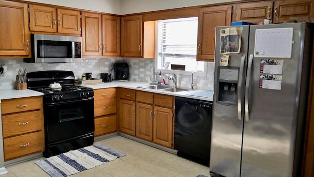 kitchen with sink, decorative backsplash, and black appliances