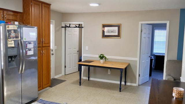 hall with light tile patterned floors