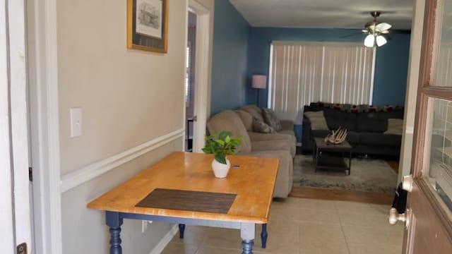 tiled living room featuring ceiling fan