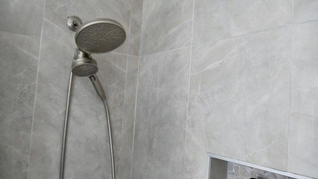 interior details featuring tiled shower