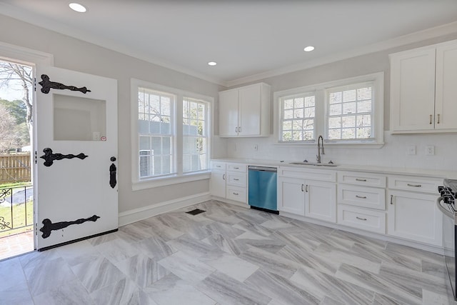 kitchen with a sink, white cabinetry, light countertops, and stainless steel dishwasher