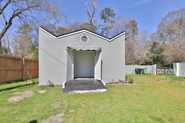 exterior space with a fenced backyard, a lawn, and stucco siding