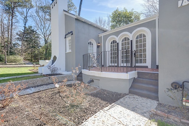 view of side of property with stucco siding