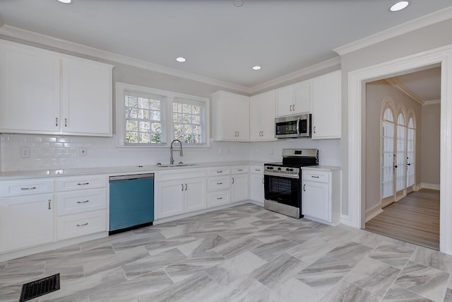 kitchen featuring a sink, stainless steel appliances, light countertops, and white cabinetry