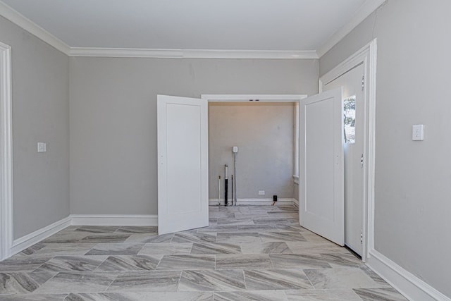 foyer entrance with baseboards and crown molding