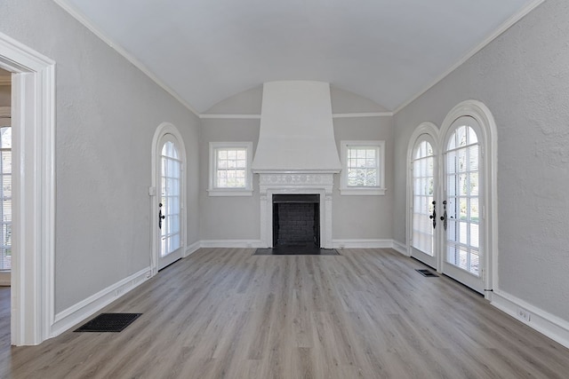 unfurnished living room with visible vents, plenty of natural light, light wood-style flooring, and baseboards