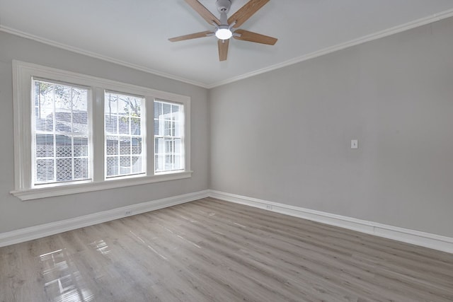 empty room featuring baseboards, plenty of natural light, and crown molding