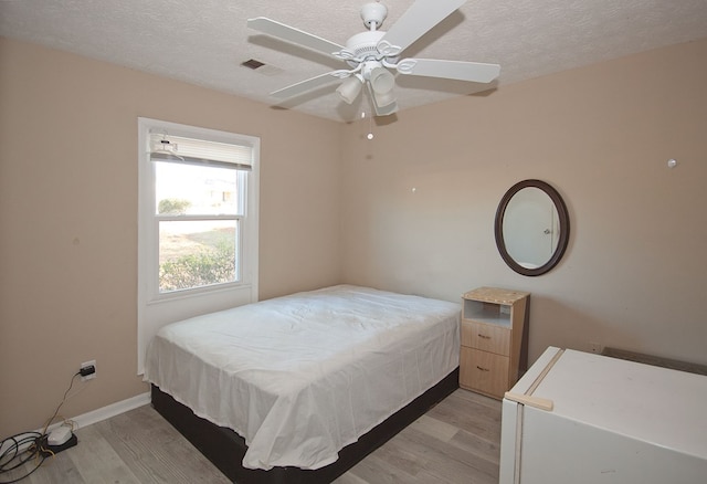 bedroom featuring ceiling fan and light wood-type flooring