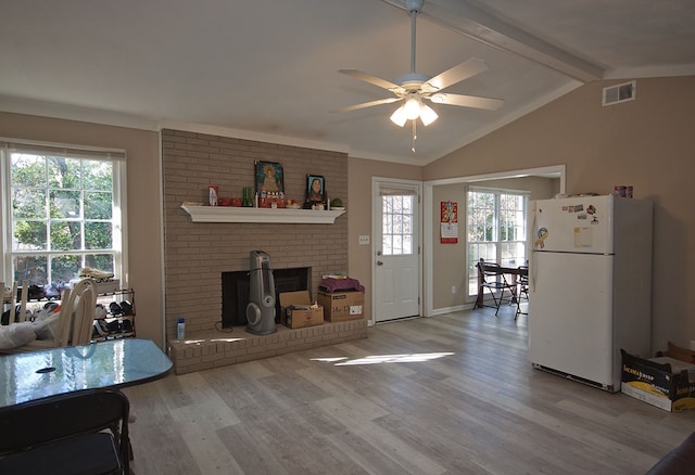 living room featuring ceiling fan, light hardwood / wood-style floors, and lofted ceiling with beams