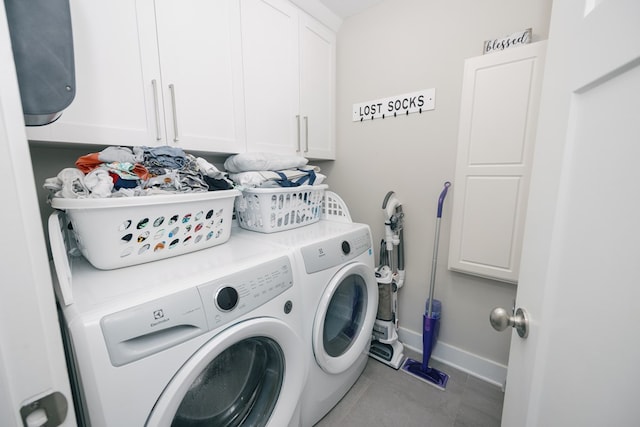 laundry room featuring cabinets and washing machine and dryer