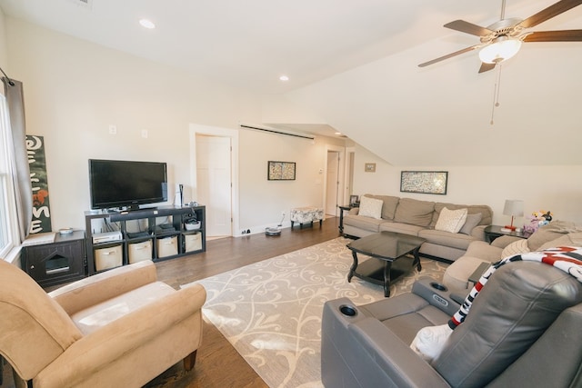 living room with dark hardwood / wood-style floors, ceiling fan, and vaulted ceiling