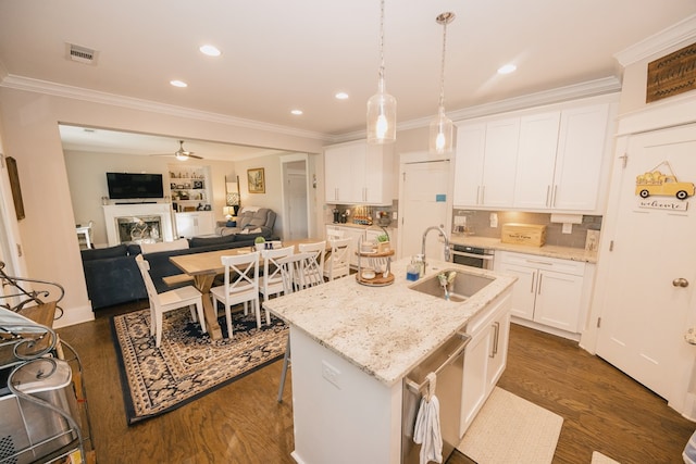 kitchen featuring ceiling fan, a kitchen island with sink, sink, dark hardwood / wood-style floors, and white cabinetry