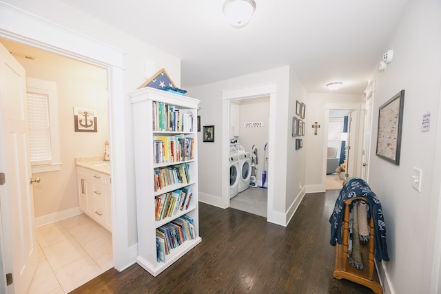 hall with dark hardwood / wood-style flooring and washer and dryer