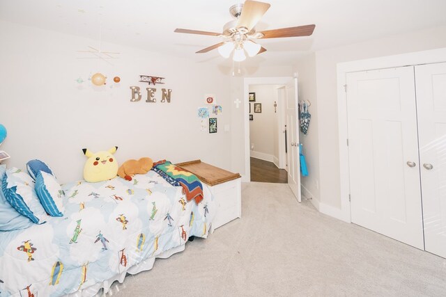 carpeted bedroom featuring ceiling fan and a closet